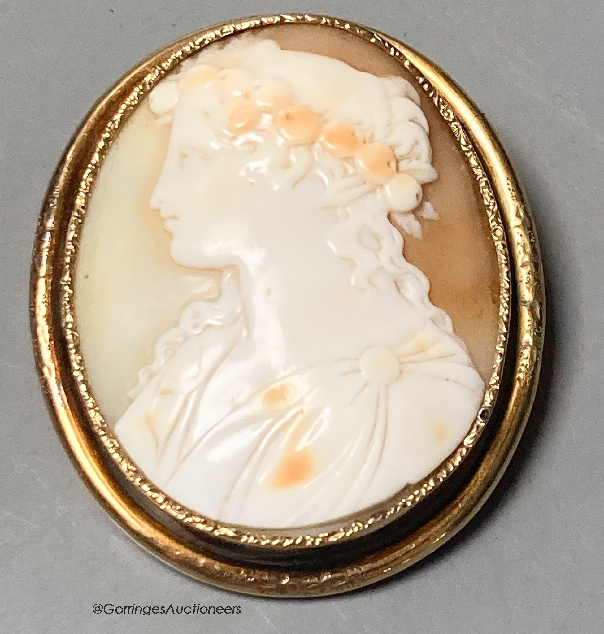 An early 20th century yellow metal mounted oval cameo shell brooch, carved with the bust of a lady to dexter, 47mm, gross 14.2 grams.